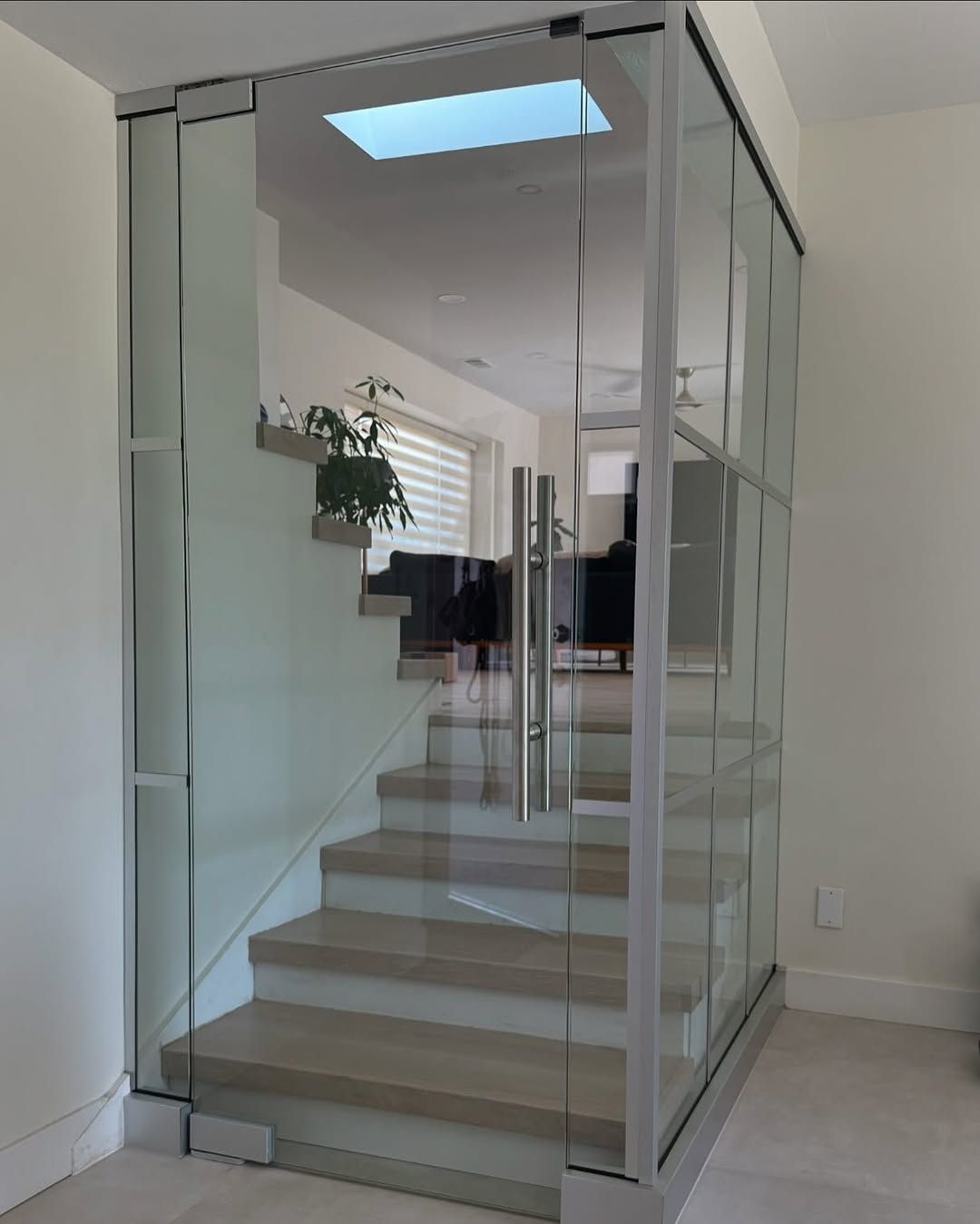A set of stairs with a glass wall between them