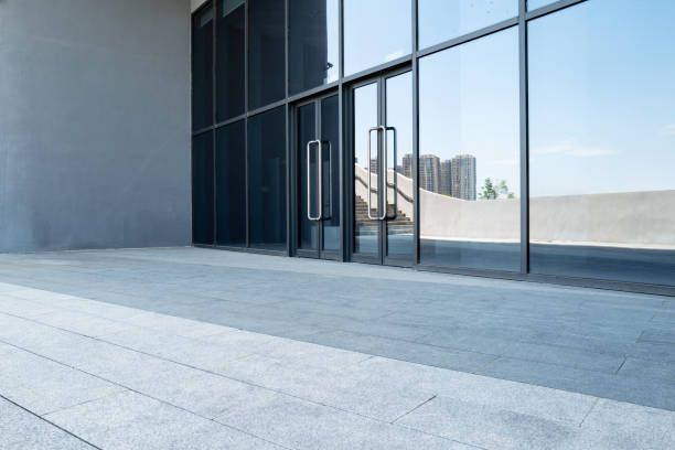 A large building with a lot of windows and a walkway leading to it.