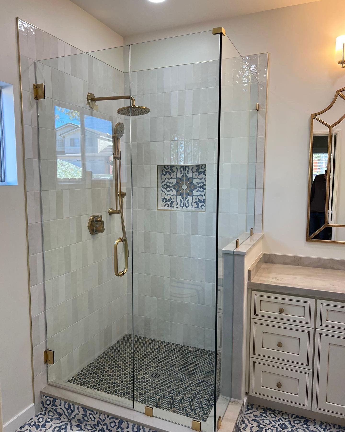 A bathroom with a walk in shower and a mirror.