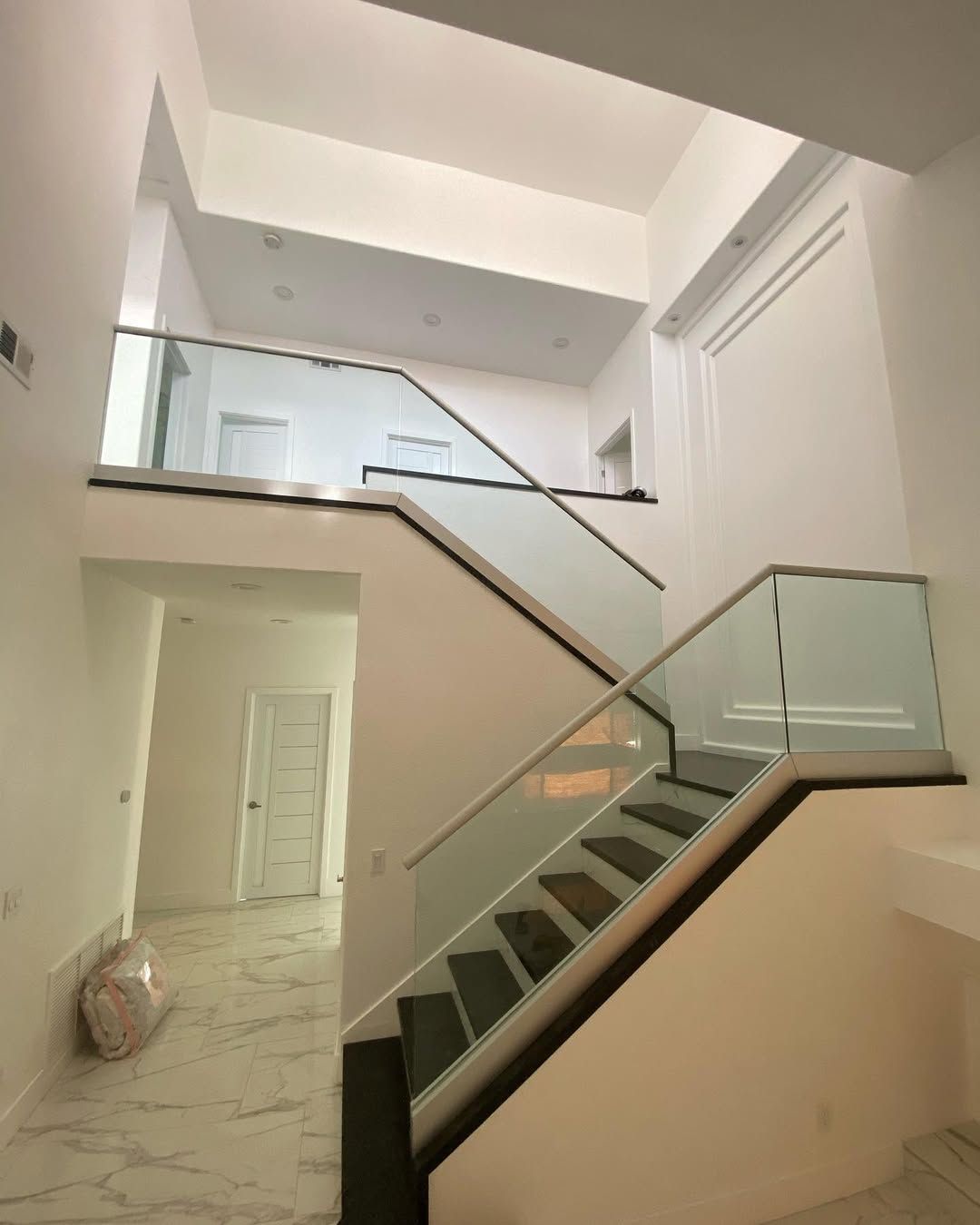 A staircase with a glass railing in a house