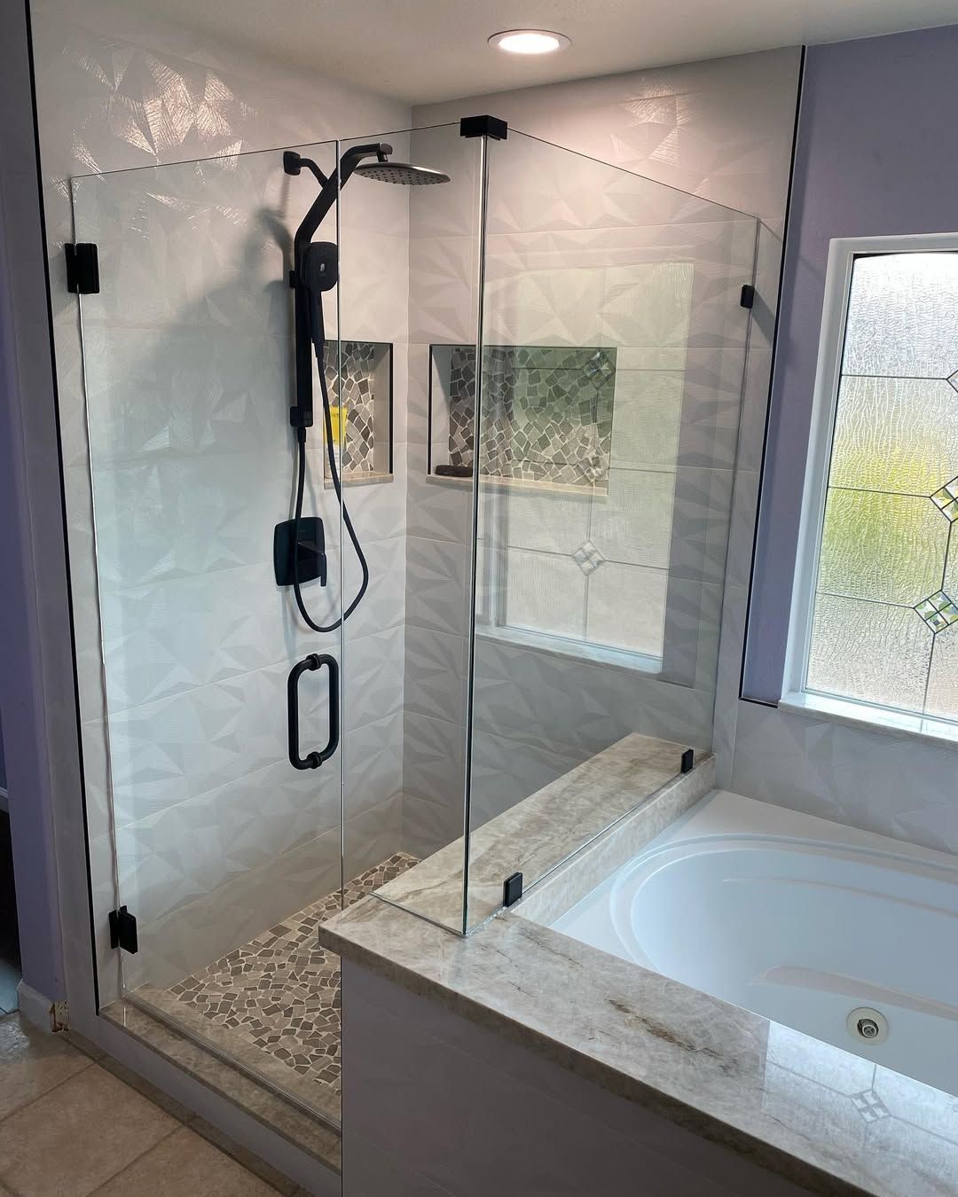 A bathroom with a walk in shower and a bathtub.