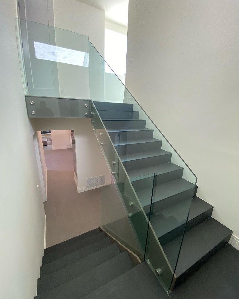 A staircase with a glass railing in a house