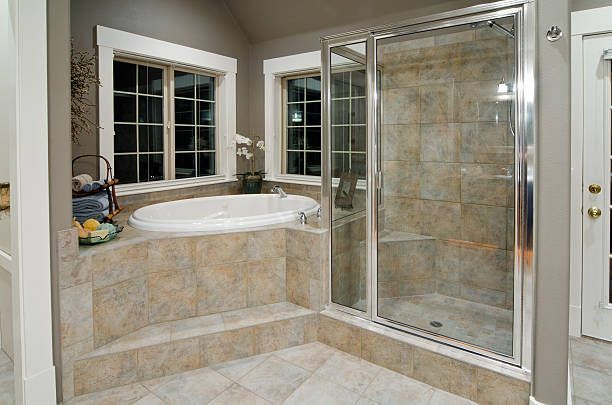 A bathroom with a jacuzzi tub and a walk in shower.