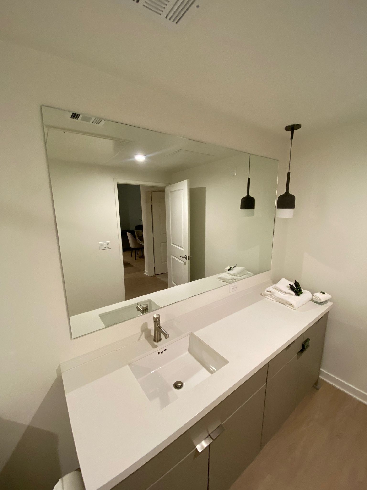A bathroom with two sinks and a large mirror.
