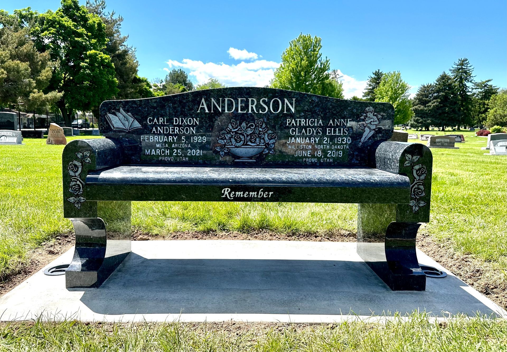 Black granite bench in a cemetery, engraved with the name Anderson and memorial text.