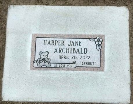 Headstone for Harper Jane Archibald, born April 26, 2022, with teddy bear and Sprout.