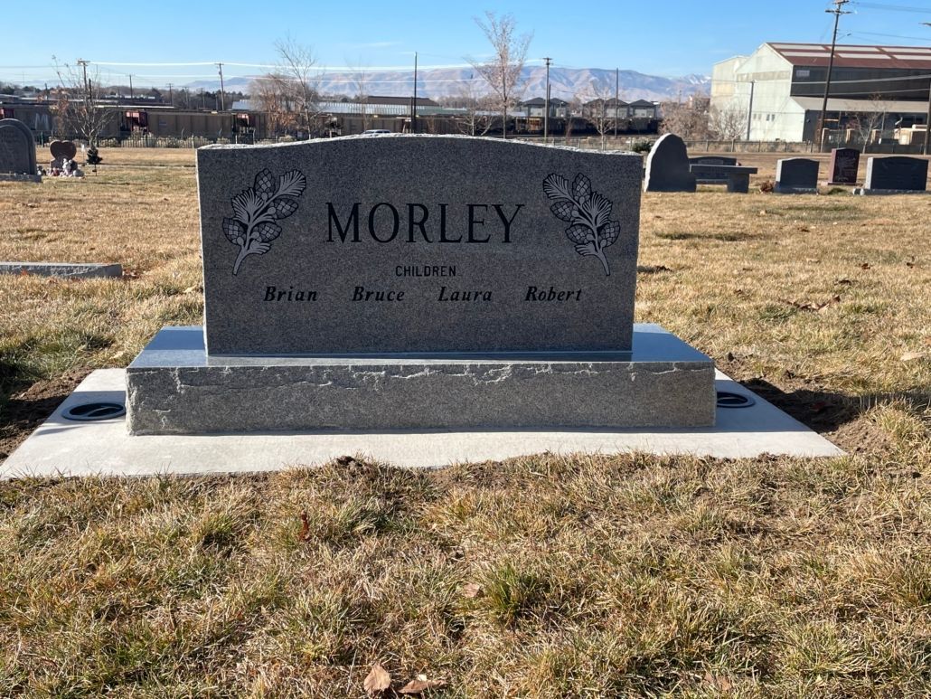 Headstone in a cemetery; gray stone with