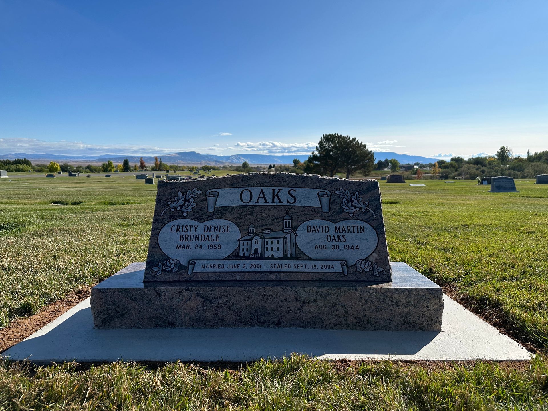 Gravestone in a grassy field with the name
