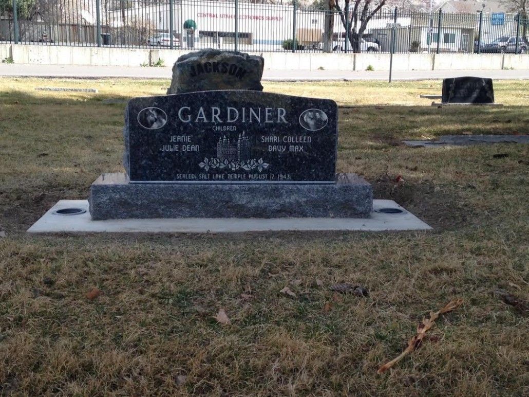 Grave marker in a cemetery. Black granite headstone for