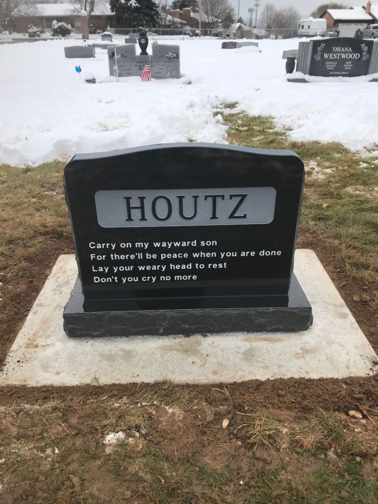 Black granite tombstone with the name