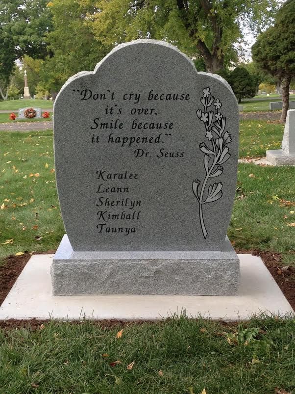 Gravestone with a Dr. Seuss quote and engraved flowers, names listed below.