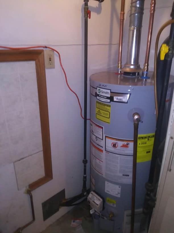 A water heater is sitting in a corner of a room