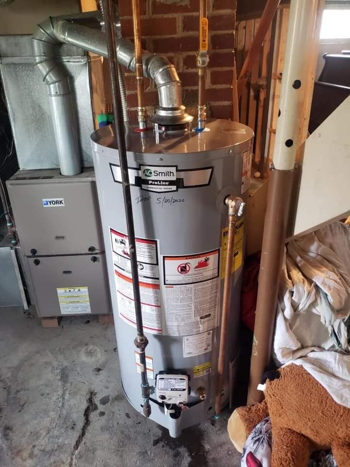A water heater is sitting in a basement.