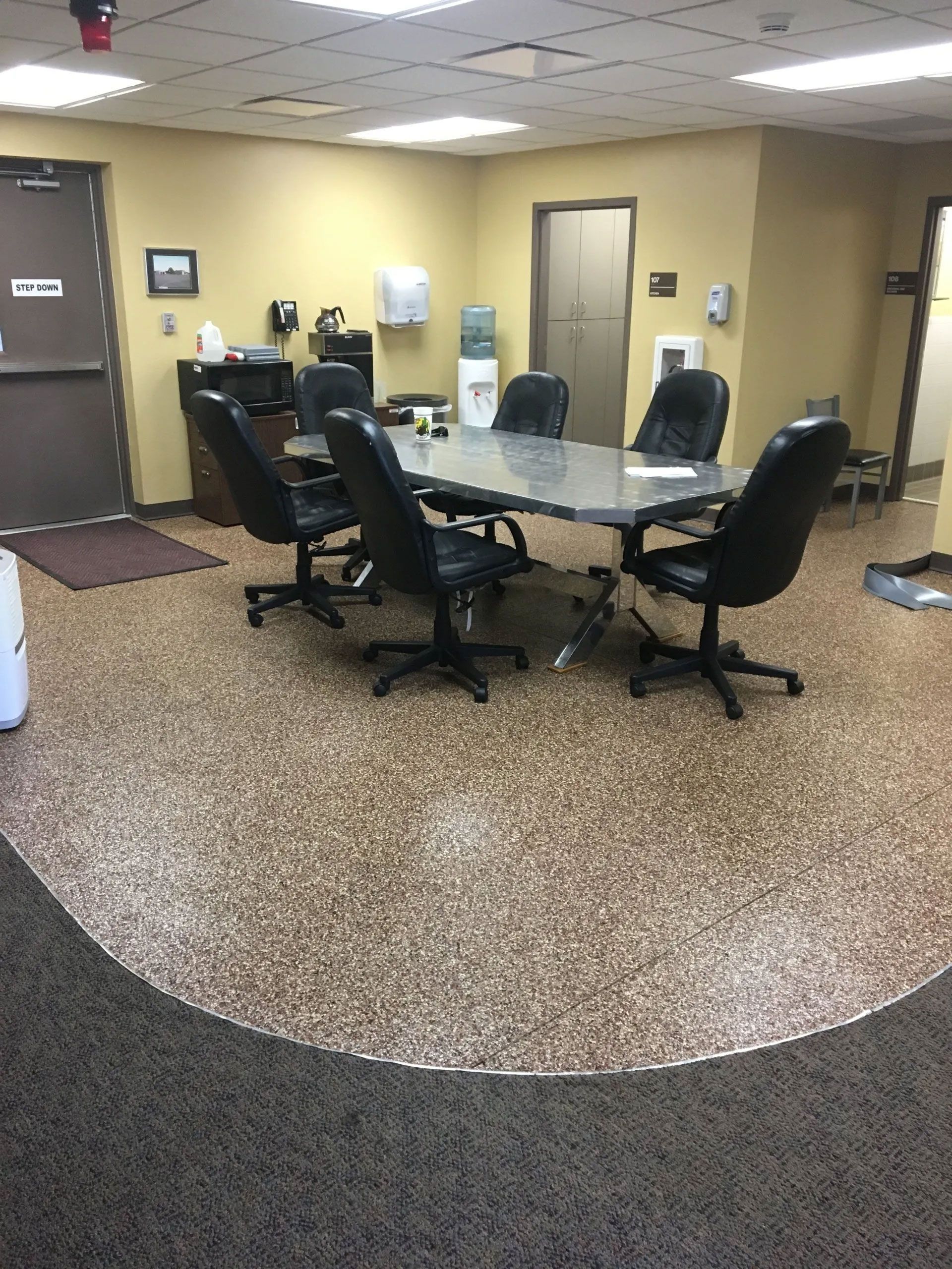 A conference room with a table and chairs in it