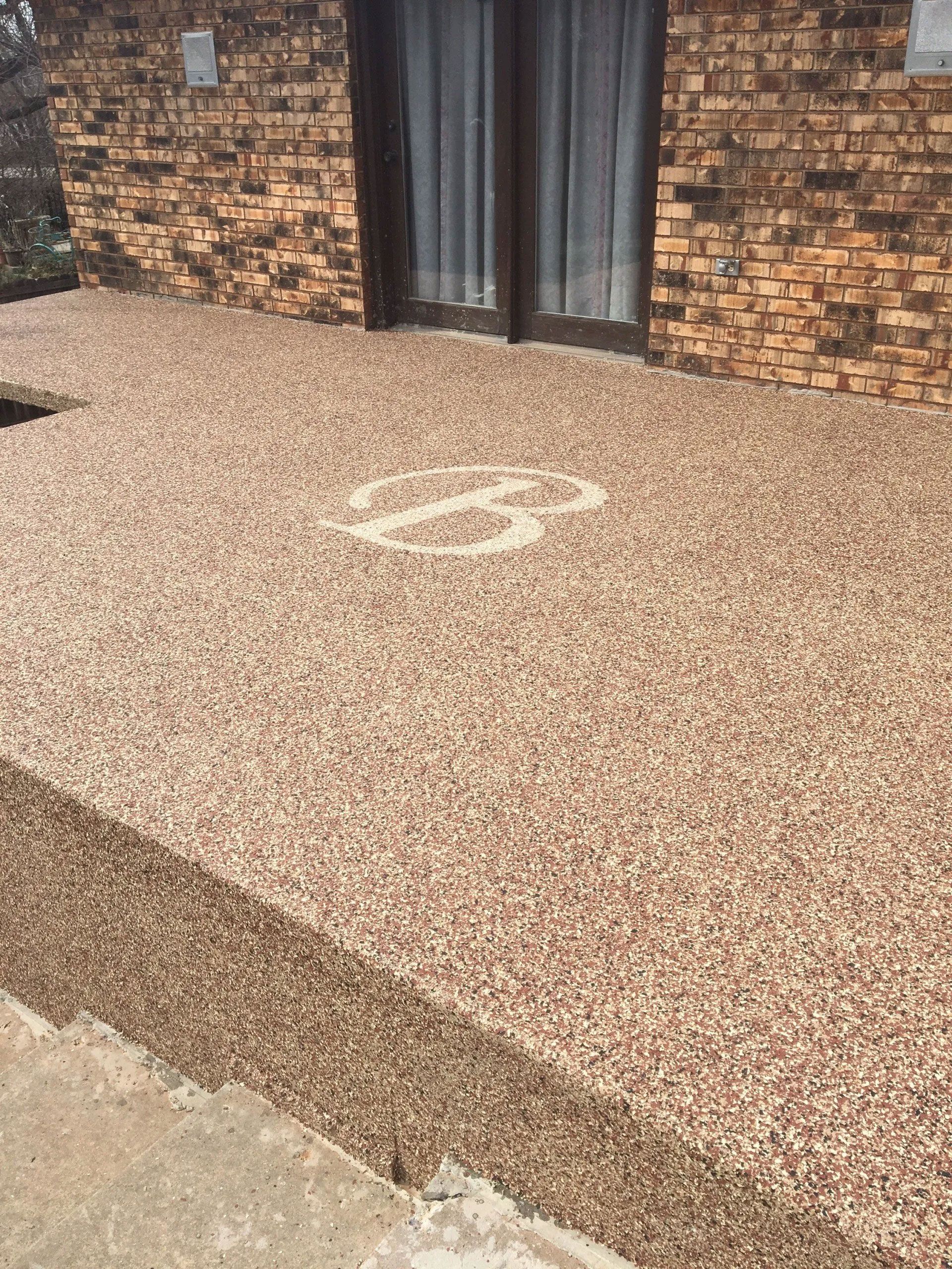A brick house with a concrete porch in front of it
