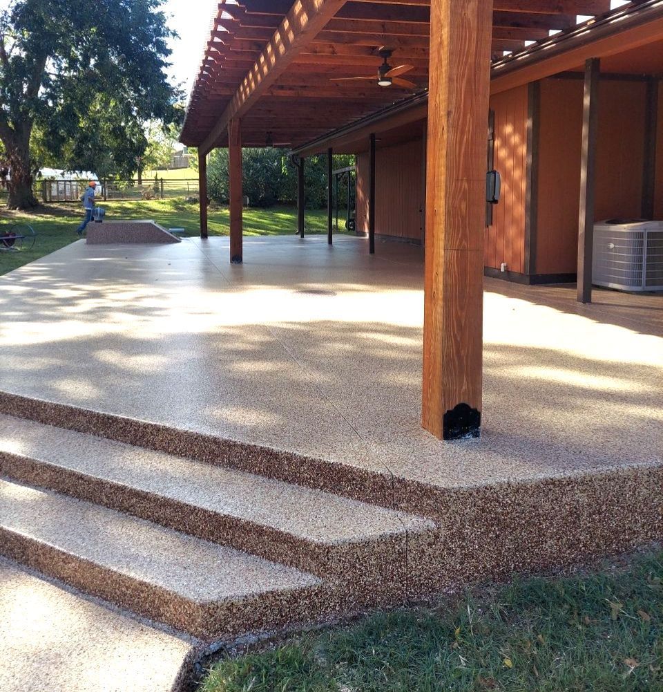 A patio with stairs leading up to it under a pergola