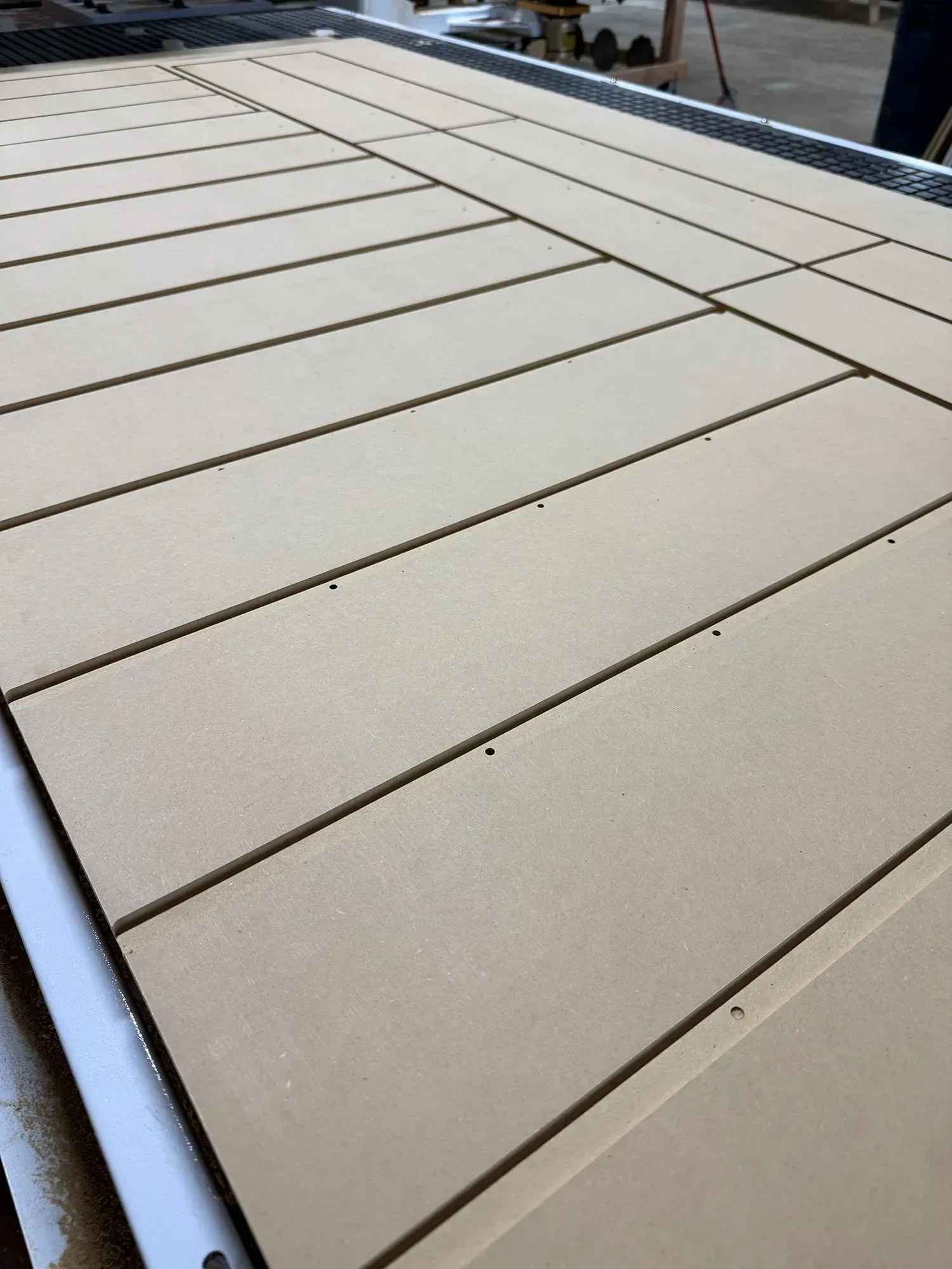 Close-up of beige tiled rooftop with dark seams and white edges.