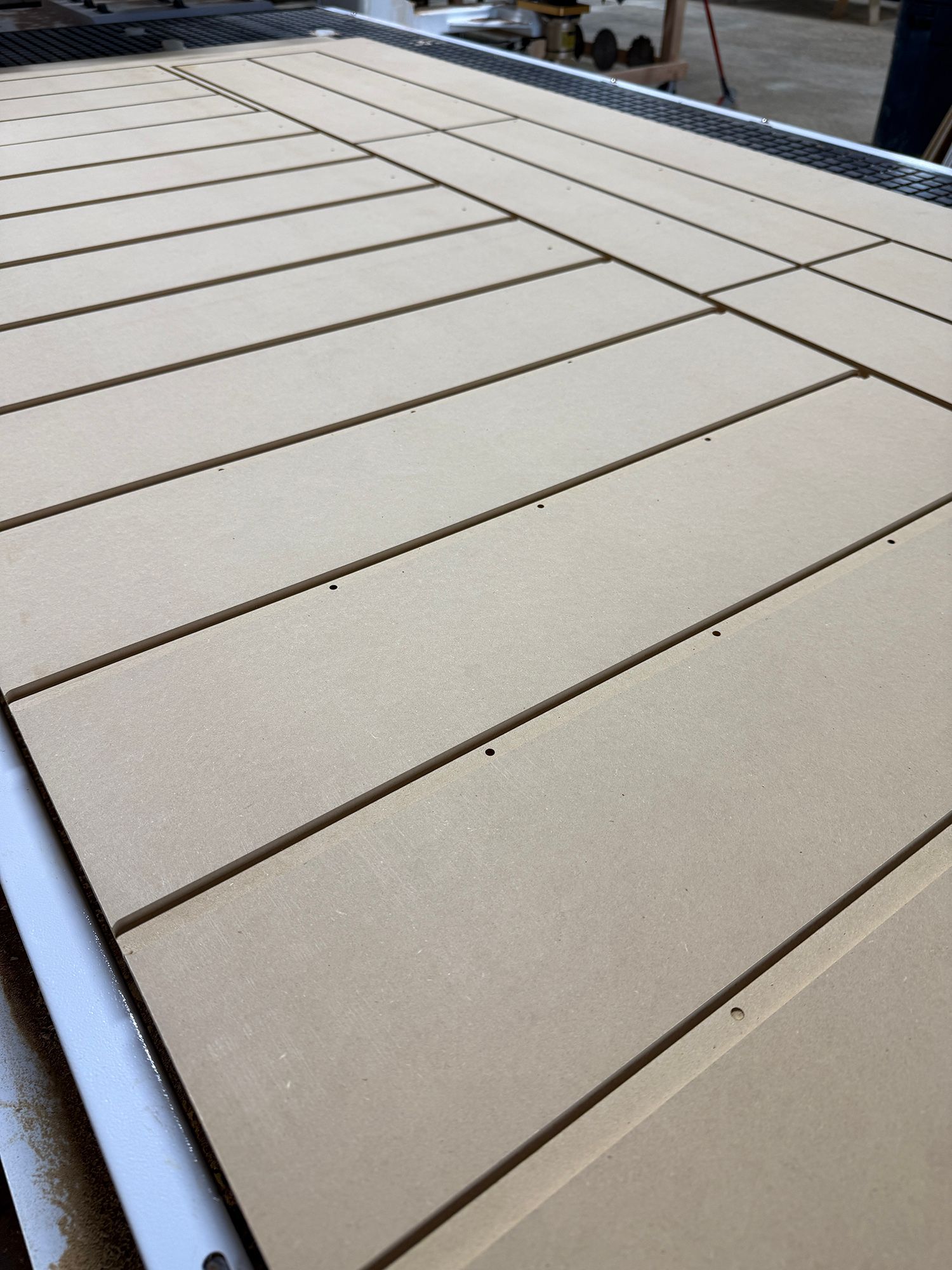 Beige wooden deck planks with dark seams, viewed from a low angle outdoors.