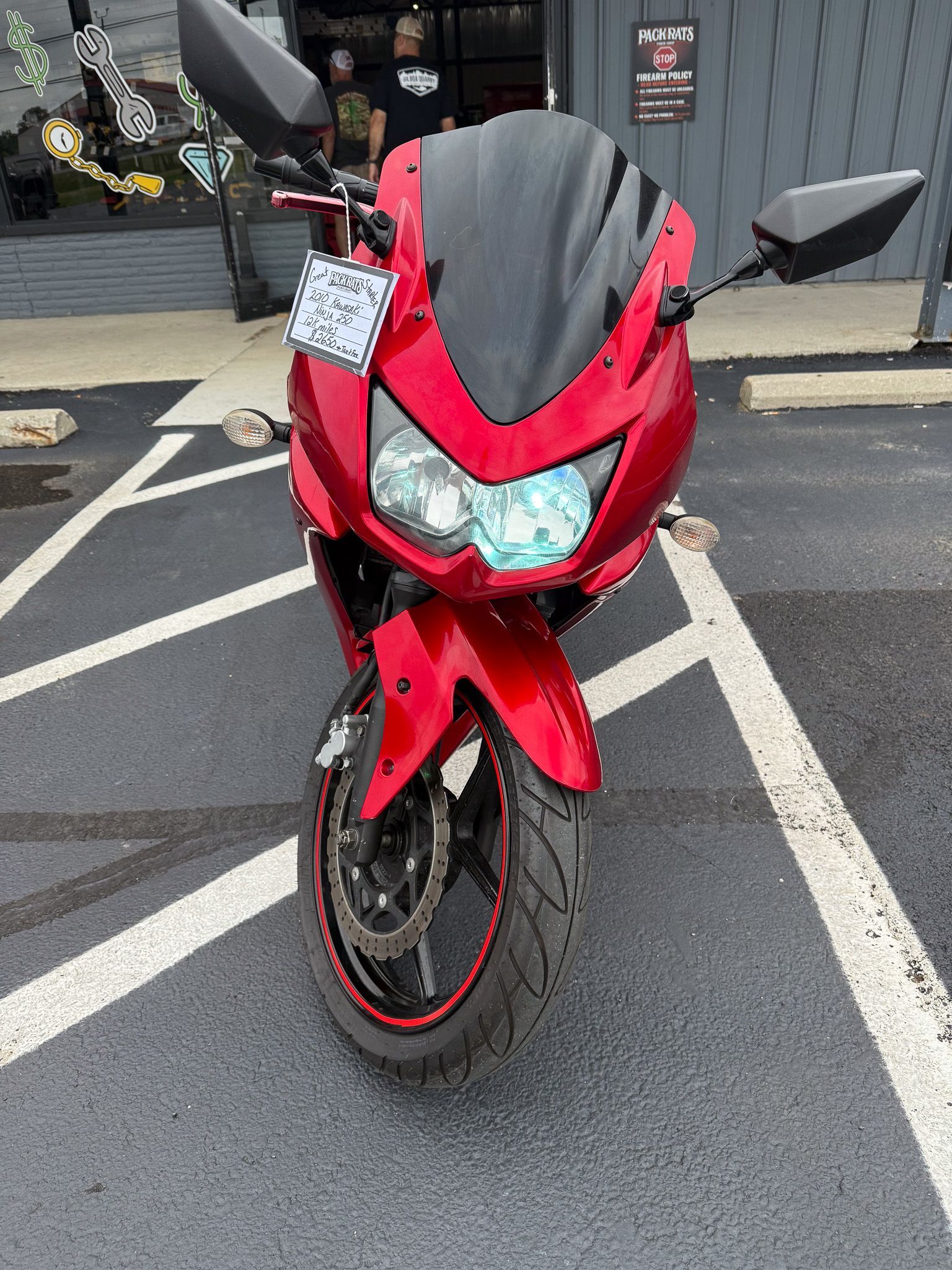 Red Kawasaki Ninja motorcycle parked in a parking lot.
