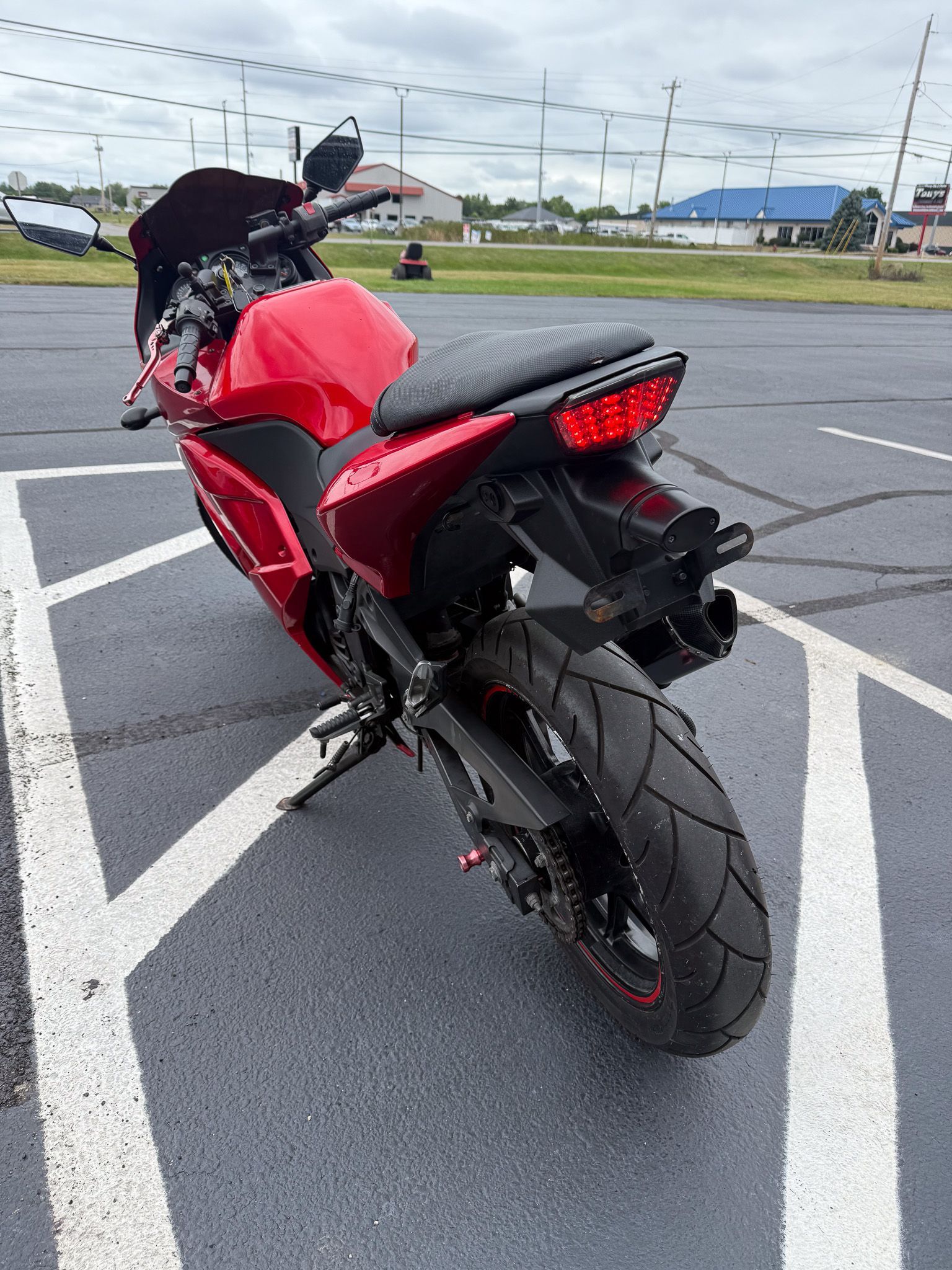 Red motorcycle parked in a parking spot.