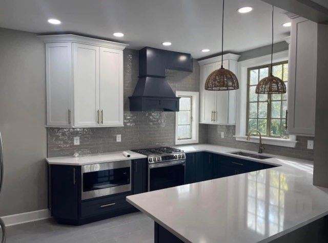 A kitchen with blue cabinets and white counter tops
