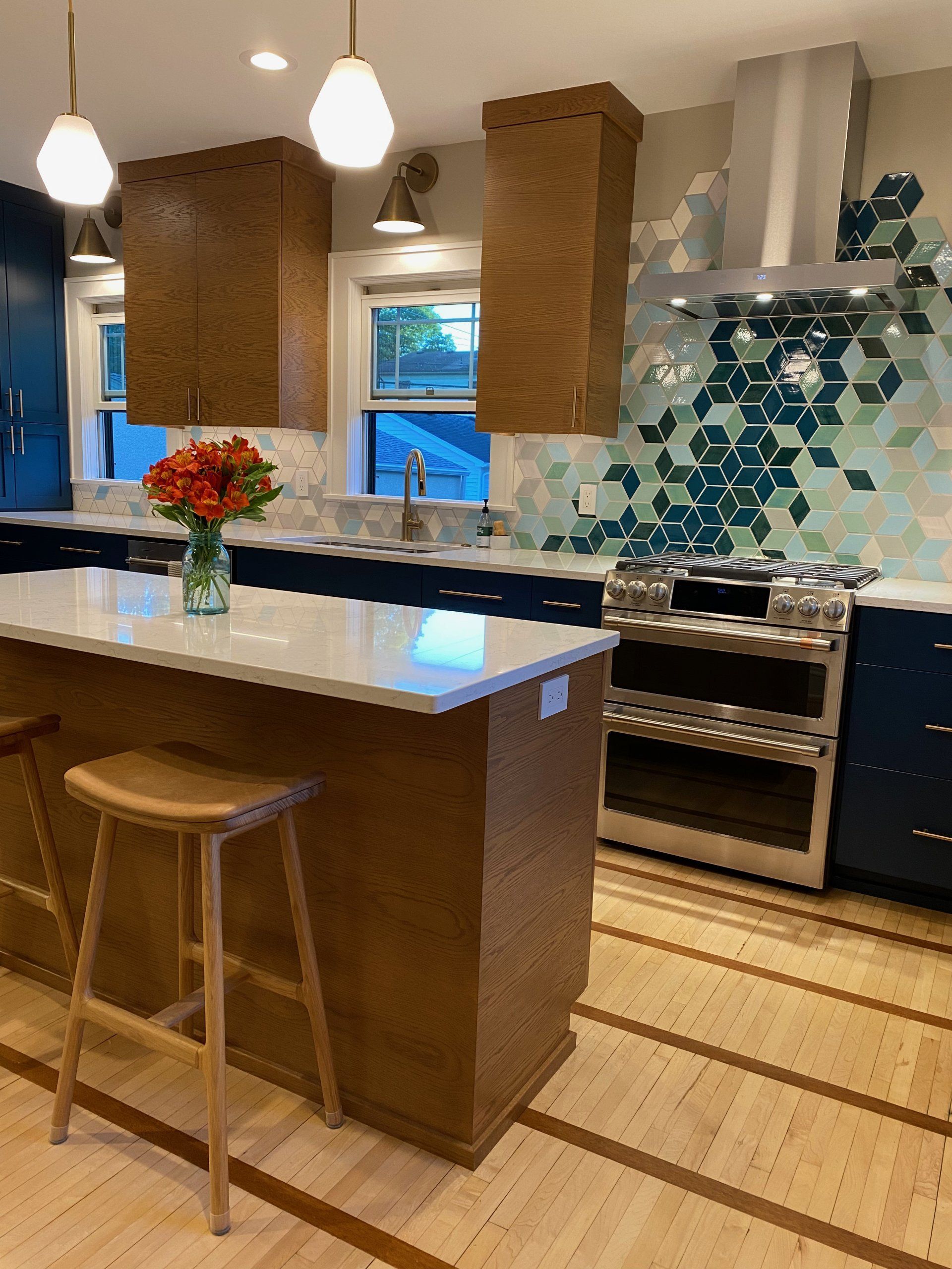 remodeled kitchen with a vase of red flowers on countertop