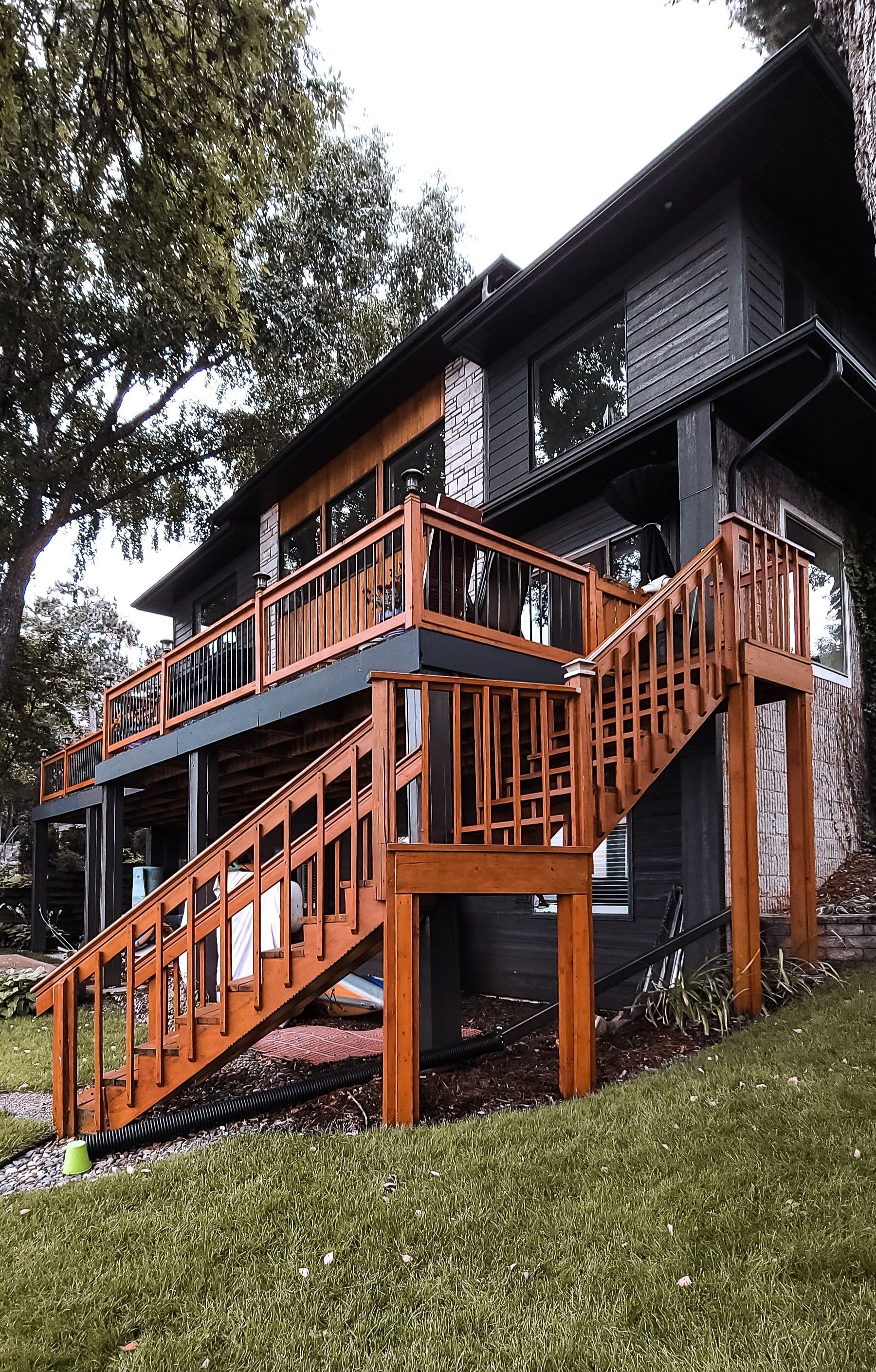 black house with wooden stairs