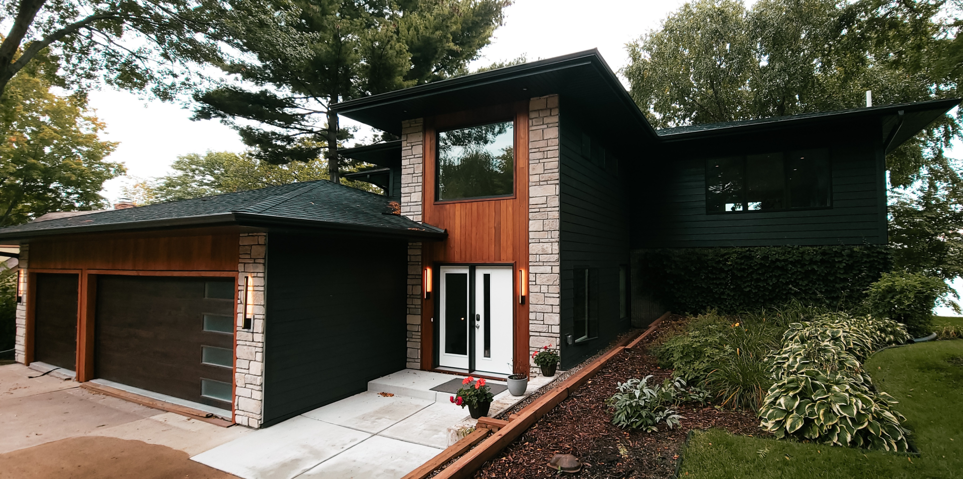 black house with plants on the side