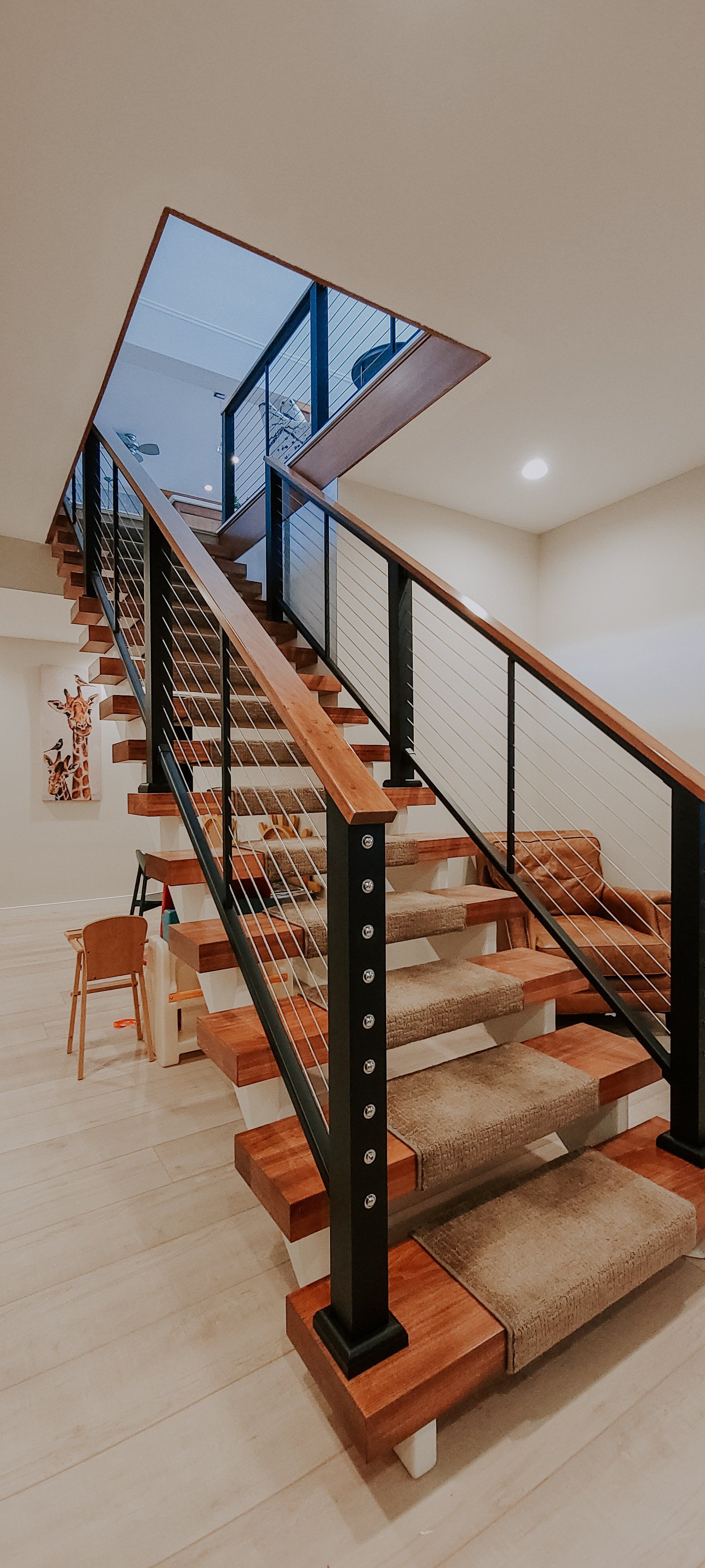 wood staircase with black metal frame
