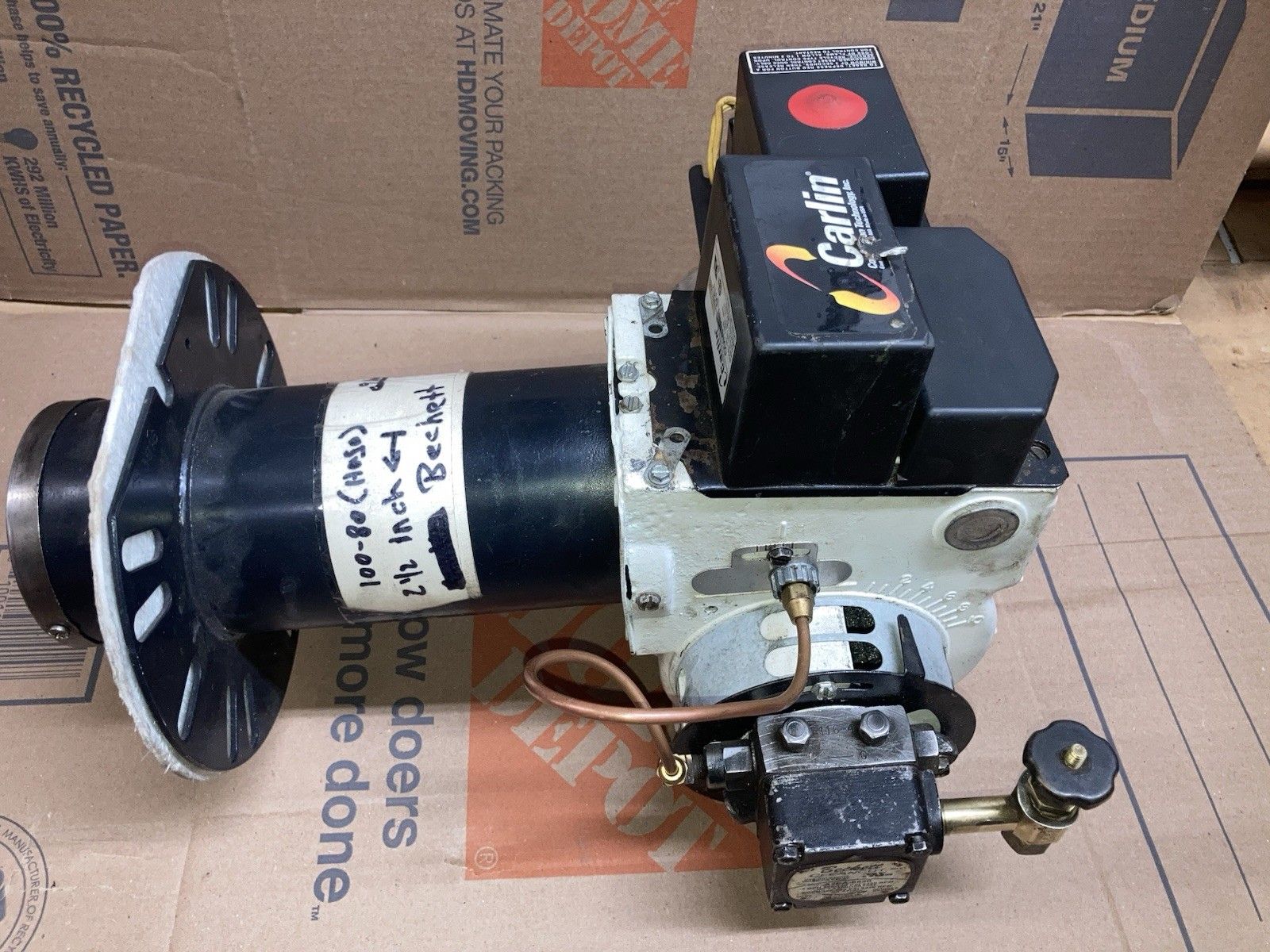 Oil burner with black, tan, and copper components, labeled