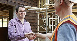 Customer shaking hands with builder