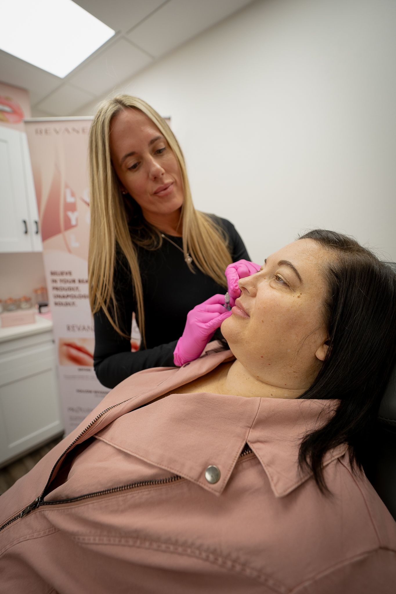 A woman is getting a botox injection in her nose.