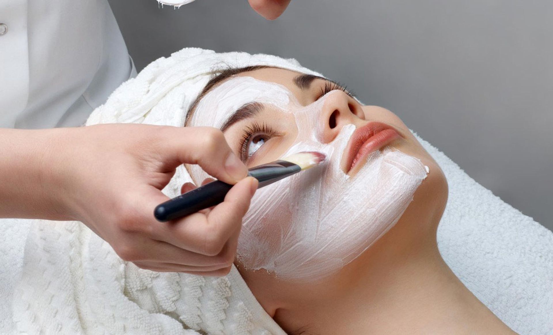 A woman is getting a facial treatment at a spa.