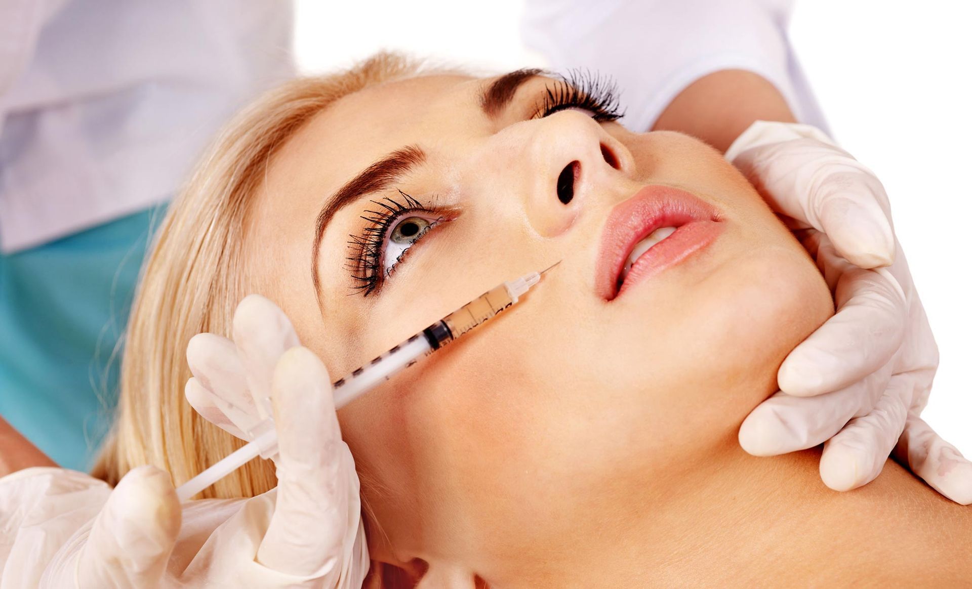 A woman is getting a botox injection in her face.