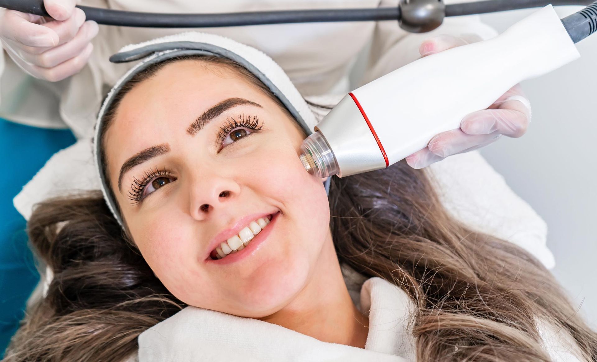 A woman is getting a facial treatment at a beauty salon.