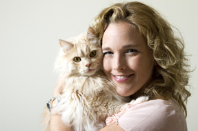 Woman hugging furry cat