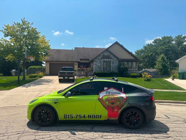 Neon green and black sports car parked in front of a suburban house on a sunny day.