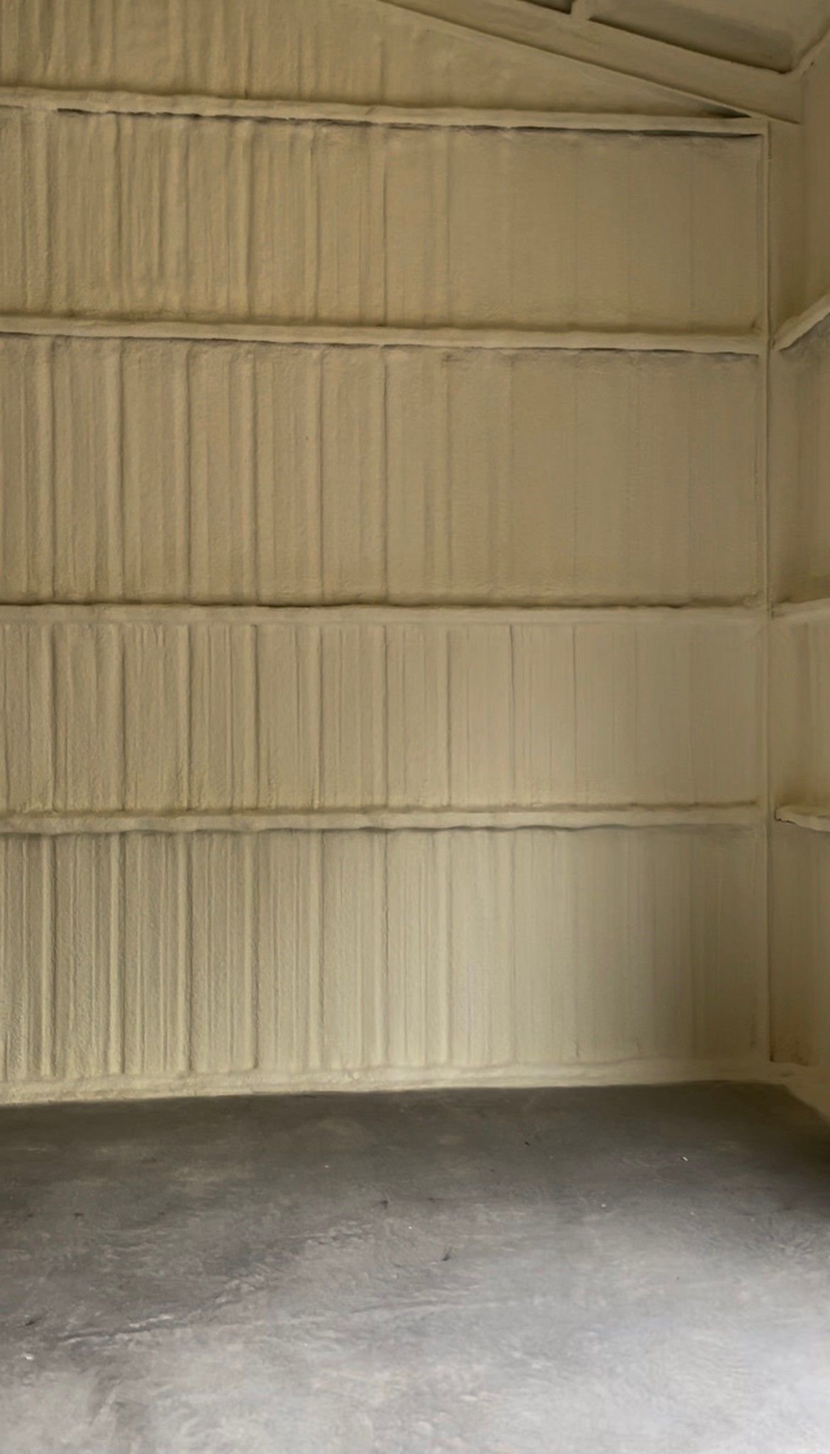 An empty garage with a lot of foam on the walls and floor.