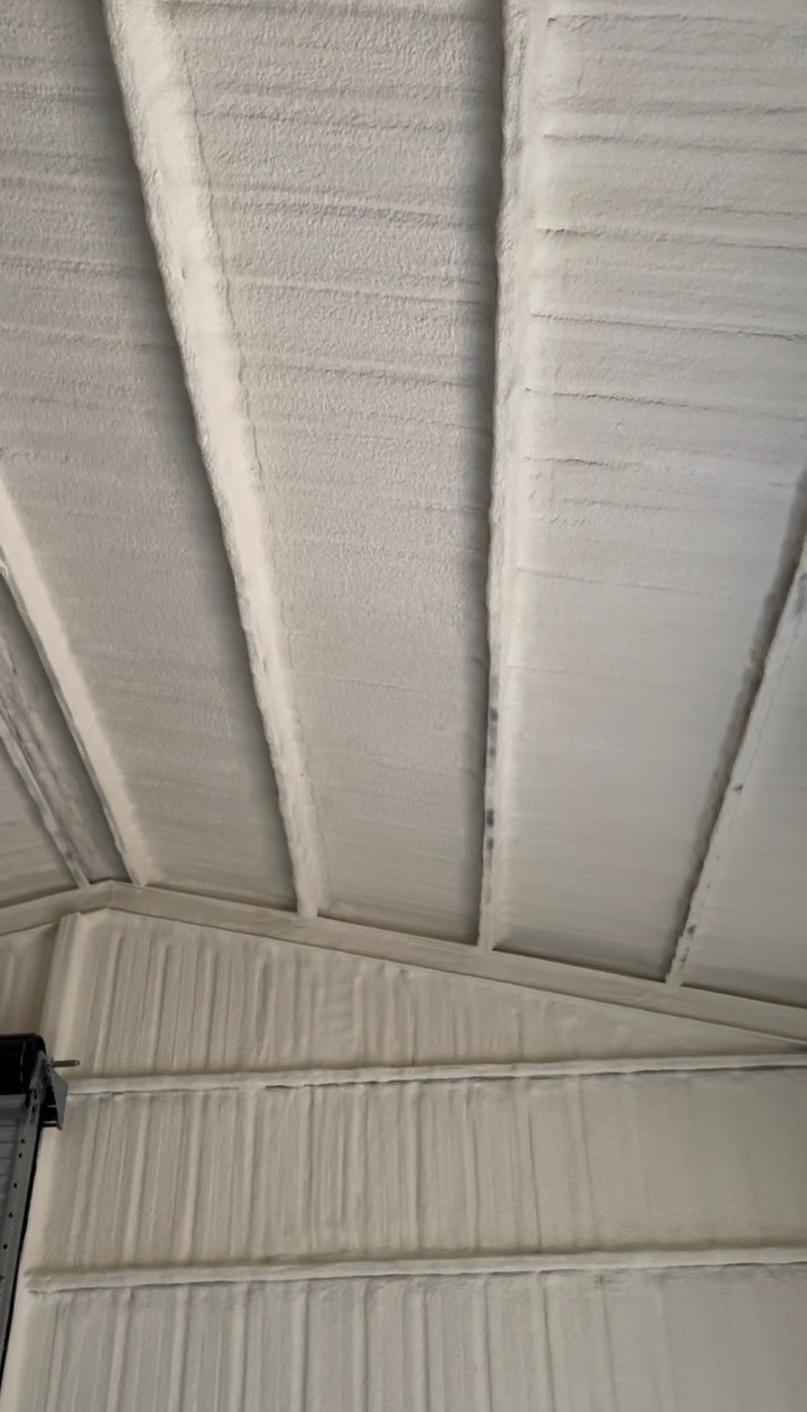 A close up of a white ceiling of a building.