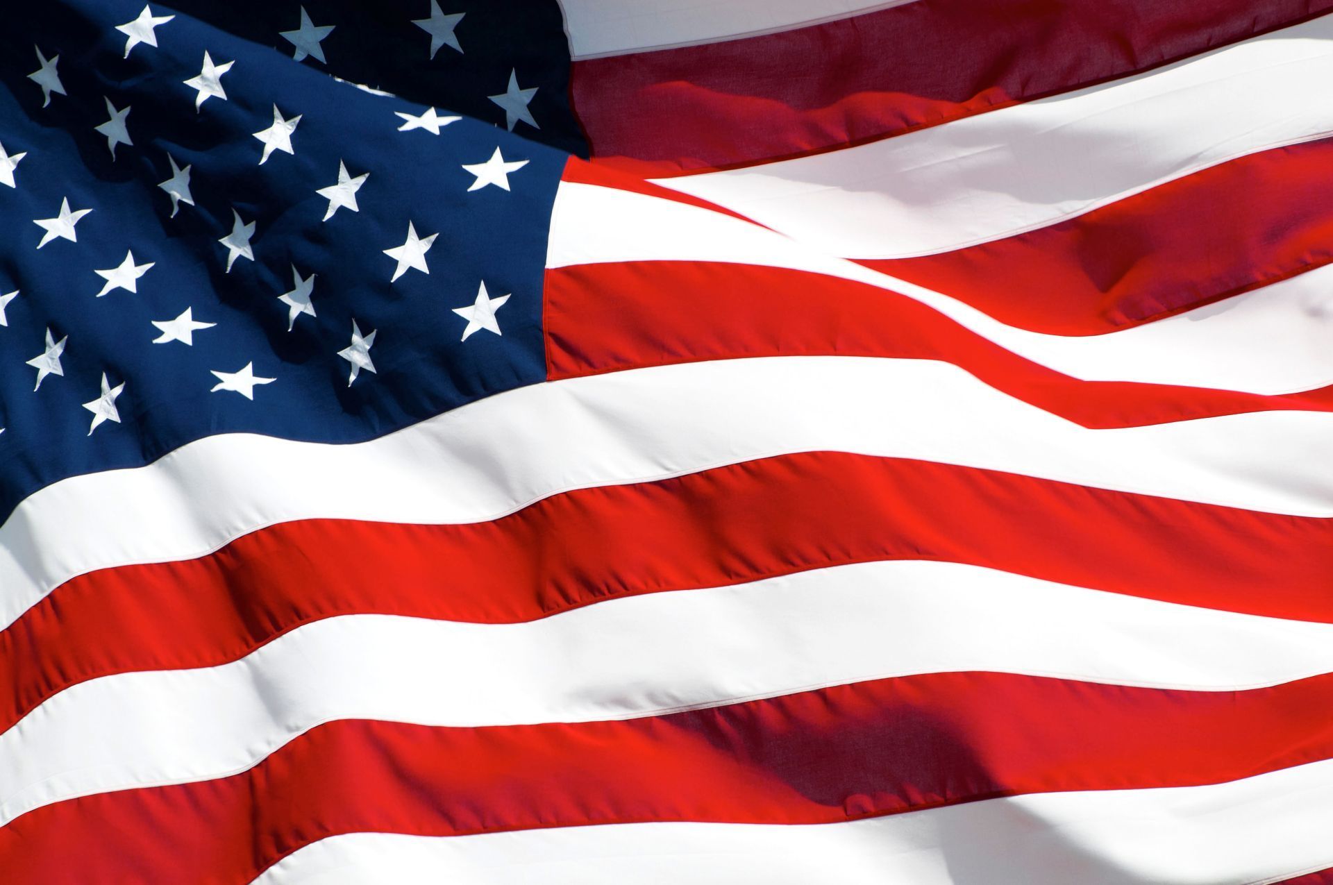 A close up of an American flag waving in the wind