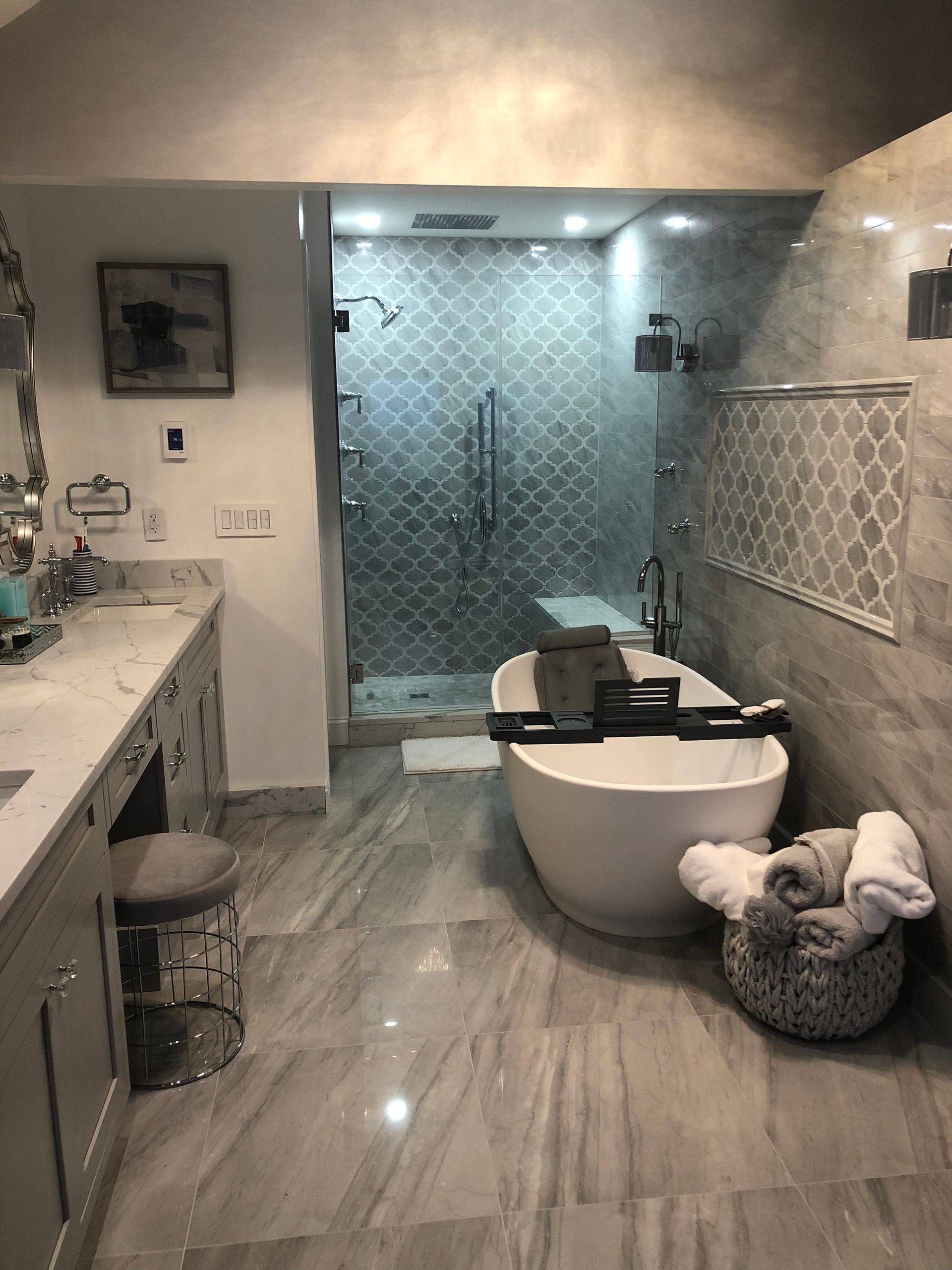 A bathroom with a tub , sink , and shower.