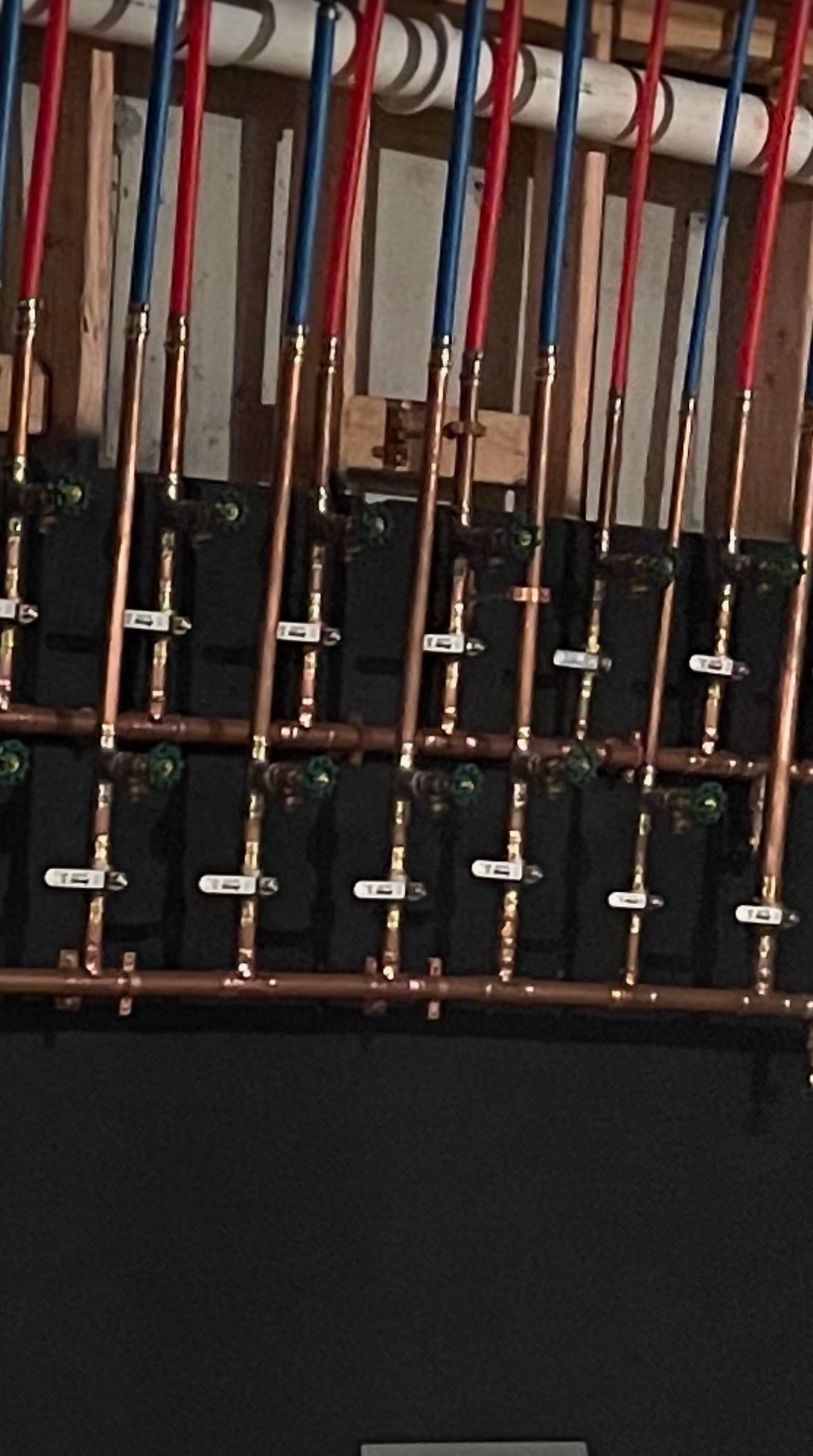 A bunch of copper pipes are lined up in a row