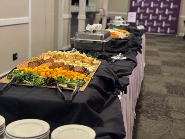 A buffet table with plates and tongs on it