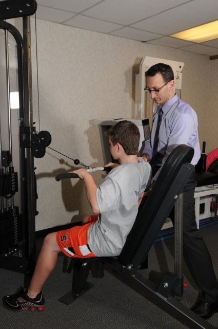 Boy using pulley machine