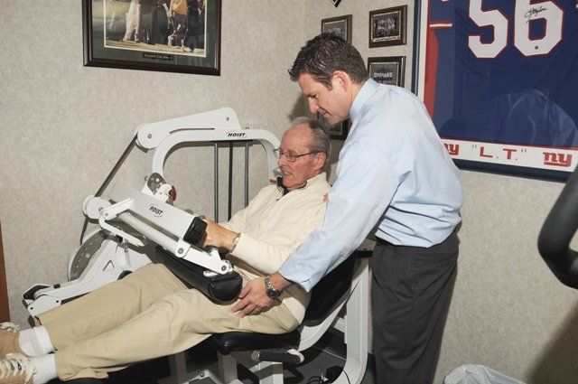 Senior using rehab machine