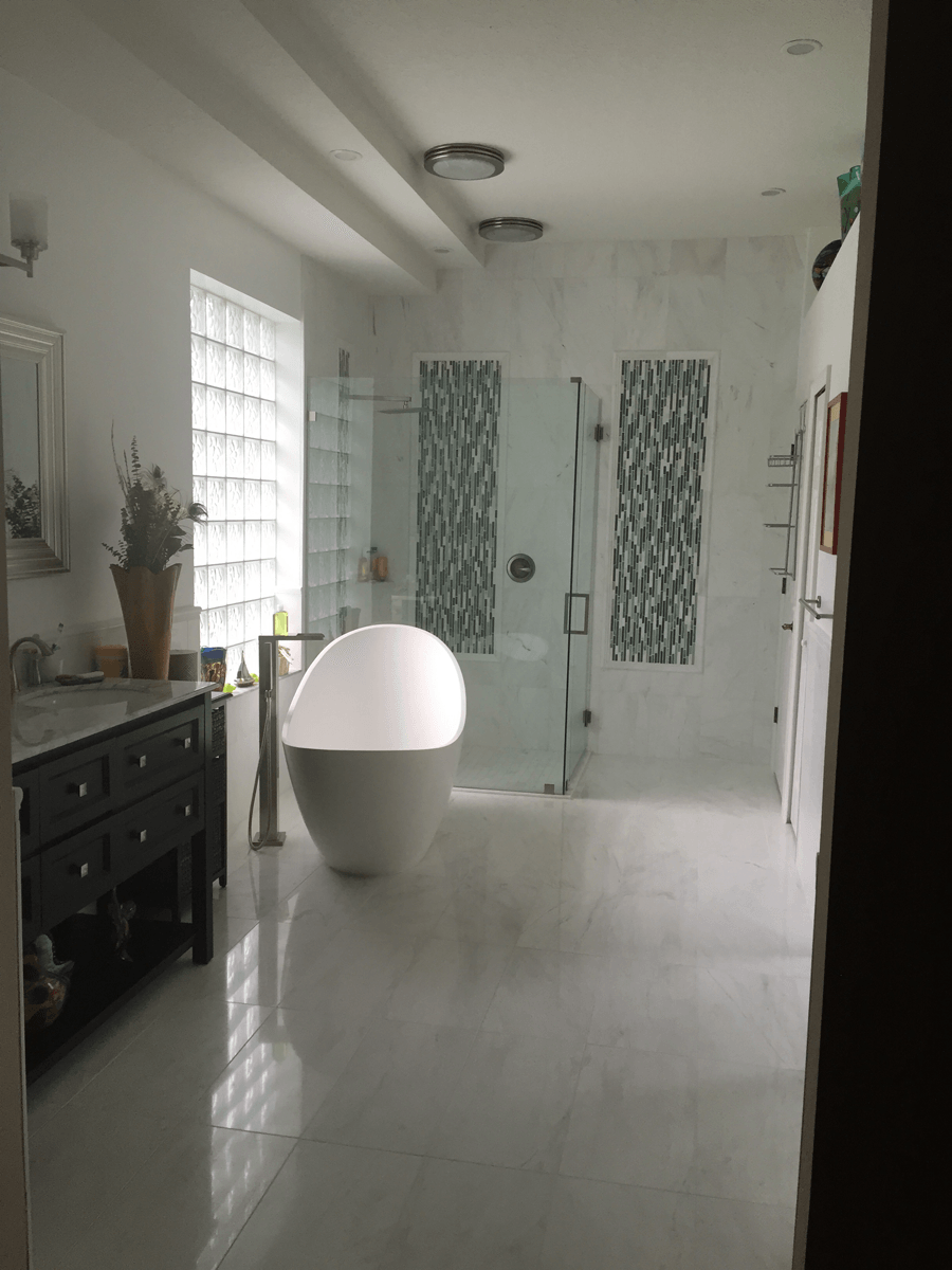 A bathroom with a bathtub and a walk in shower.
