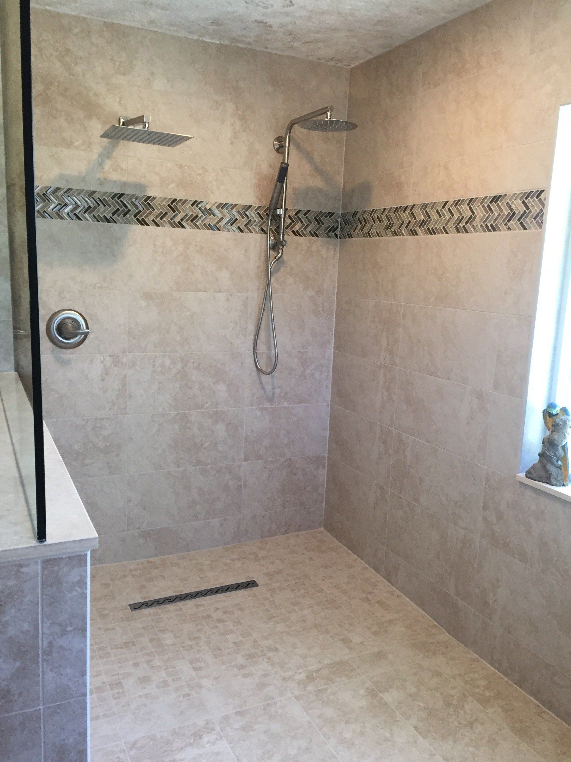 A bathroom with a walk in shower and a window