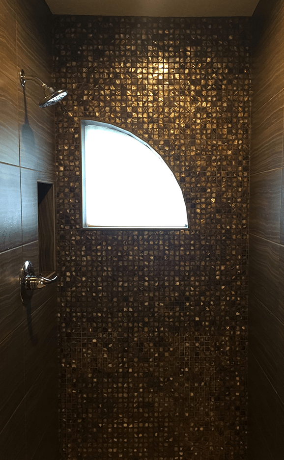 A shower with a window and a shower head