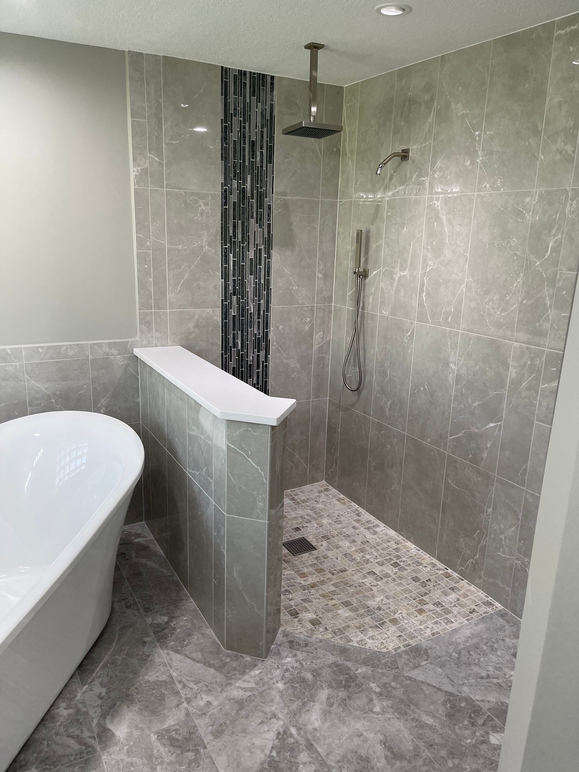 A bathroom with a bathtub and a walk-in shower.