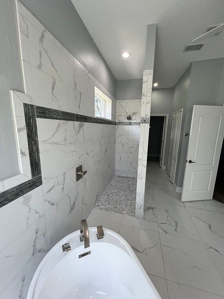 A bathroom with a bathtub and a walk in shower